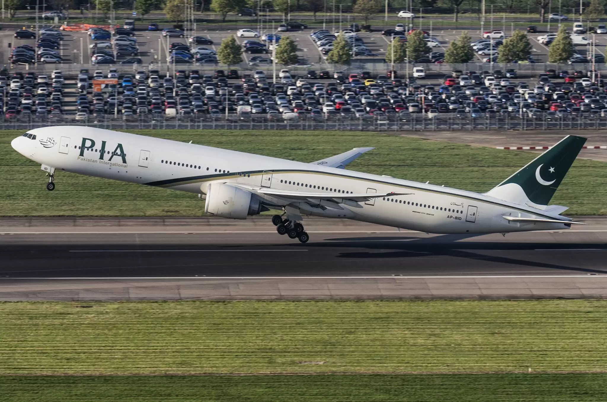 PIA aircraft at Heathrow Airport; British and Pakistani flags with aviation symbols.