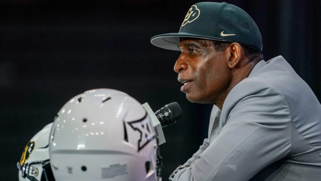 Deion Sanders smiles during cancer-free announcement at Colorado press conference.