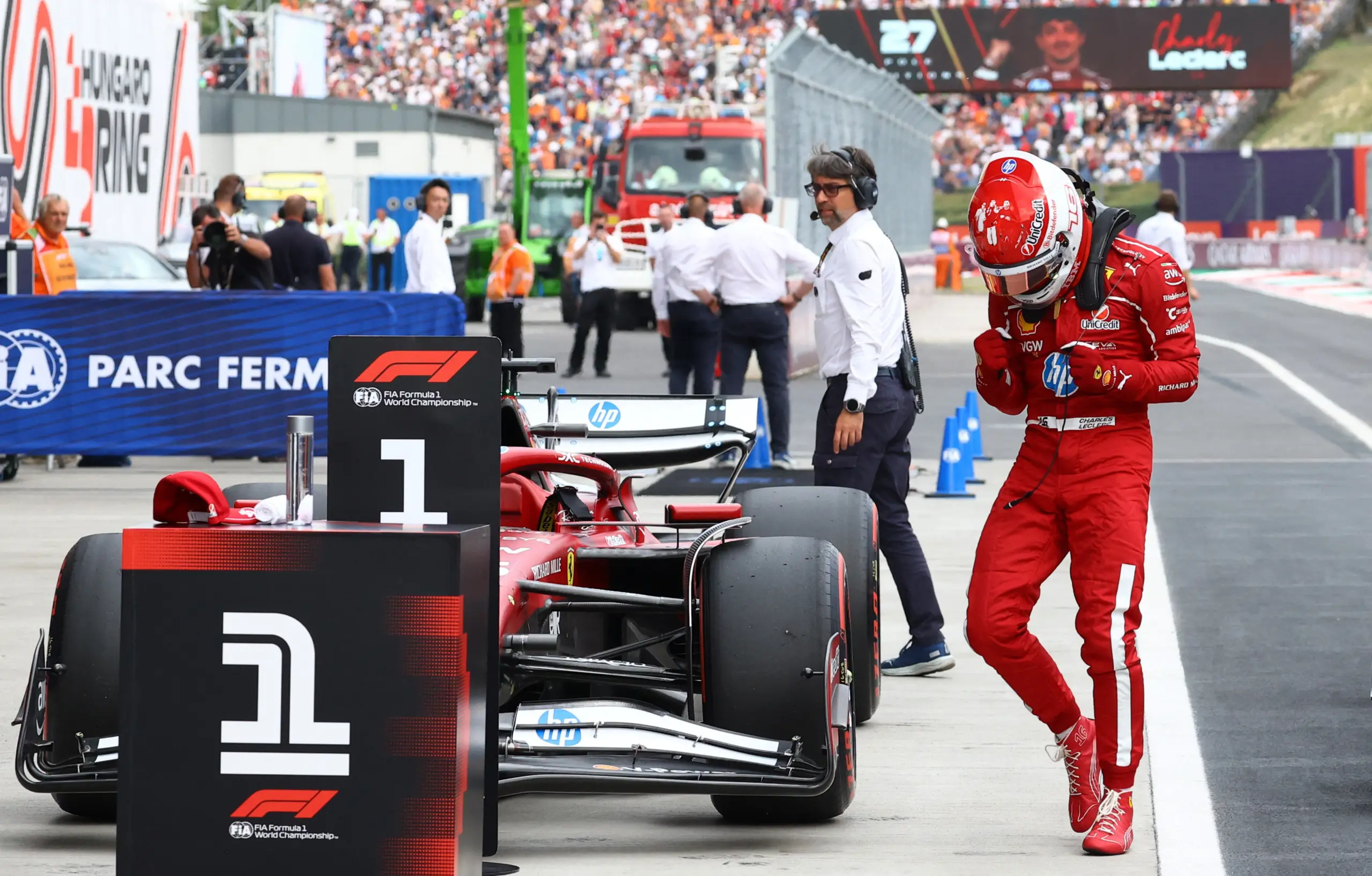 Charles Leclerc celebrating Ferrari pole position for the Hungarian GP, contrasting with Hamilton's disappointment.