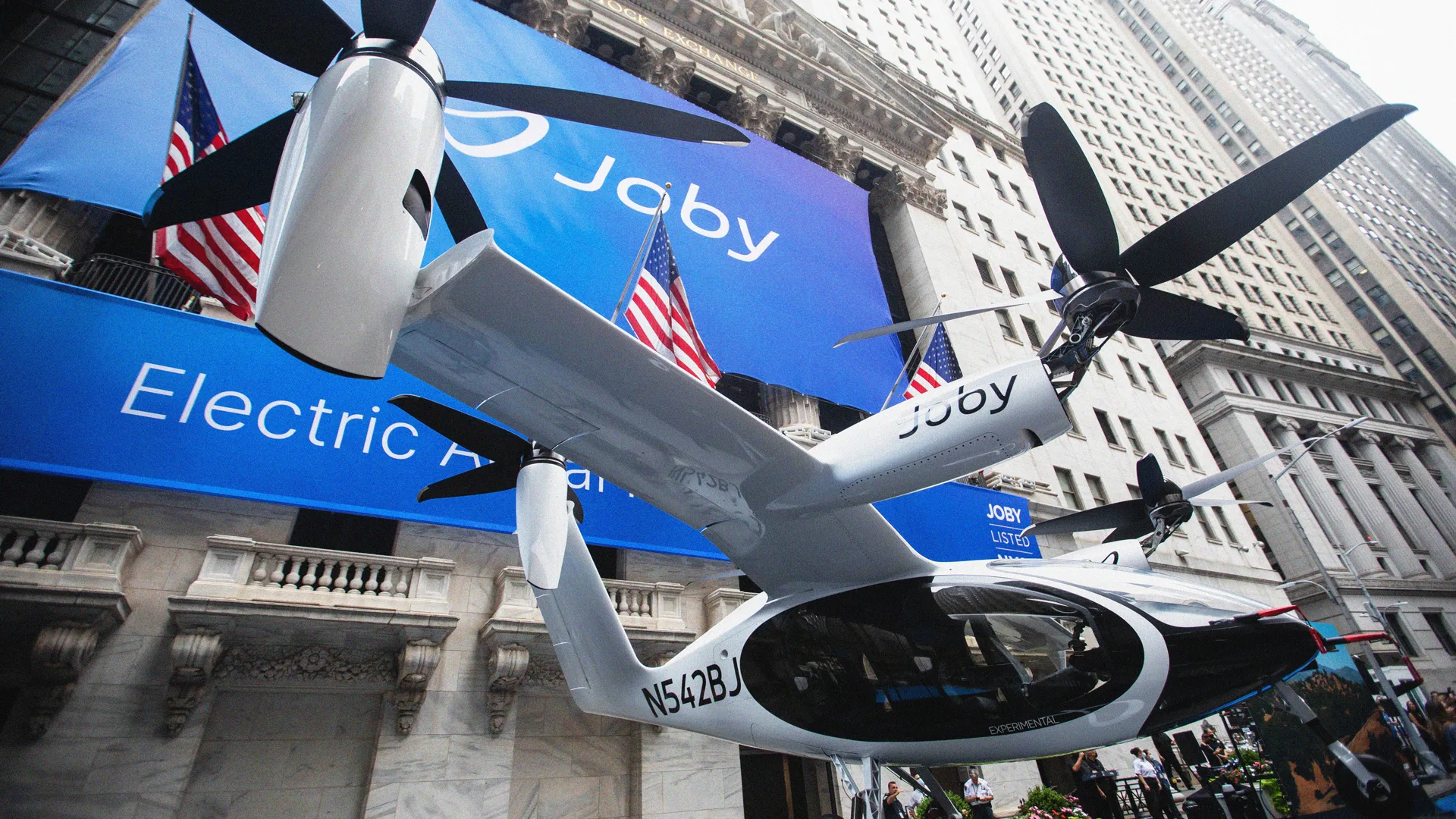 Blade Air Mobility helicopter landing in New York City, showcasing urban air mobility infrastructure acquired by Joby Aviation.